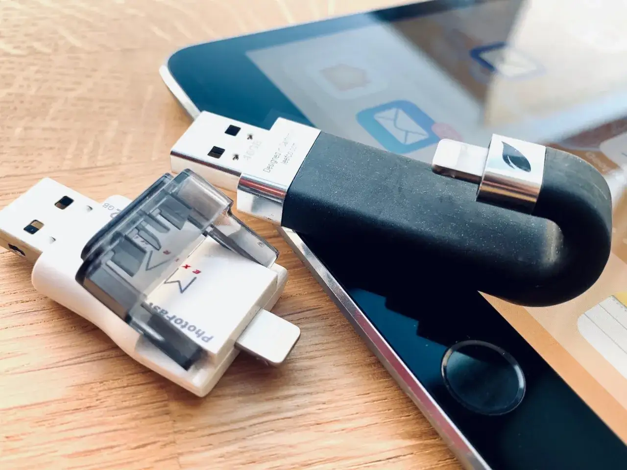Zwei USB-Sticks und ein Lightning-Speicher liegen neben einem iPad. Das iPad externe Festplatte wird nicht erkannt.