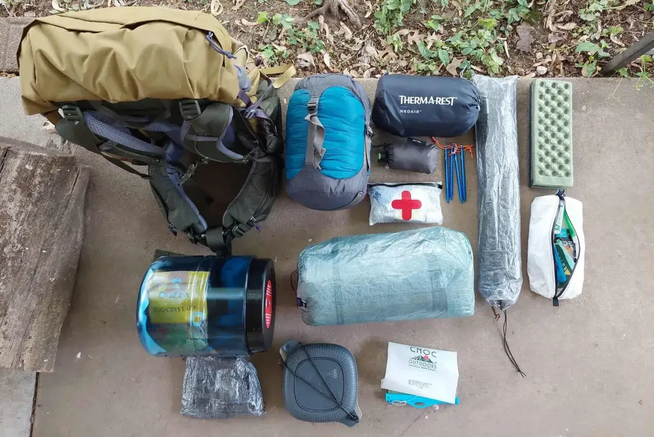 Sac à dos de randonnée, sac de couchage, matelas, trousse de secours, bâtons et autres équipements pour un poids sac randonnée optimisé.
