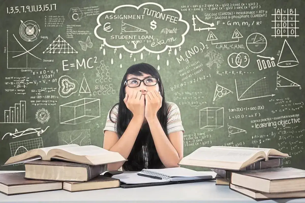 Ein M&auml;dchen mit nerv&ouml;sen Fingern blickt auf, umgeben von B&uuml;chern und Formeln. Der **Leistungsdruck Schule** scheint ihr ins Gesicht geschrieben.