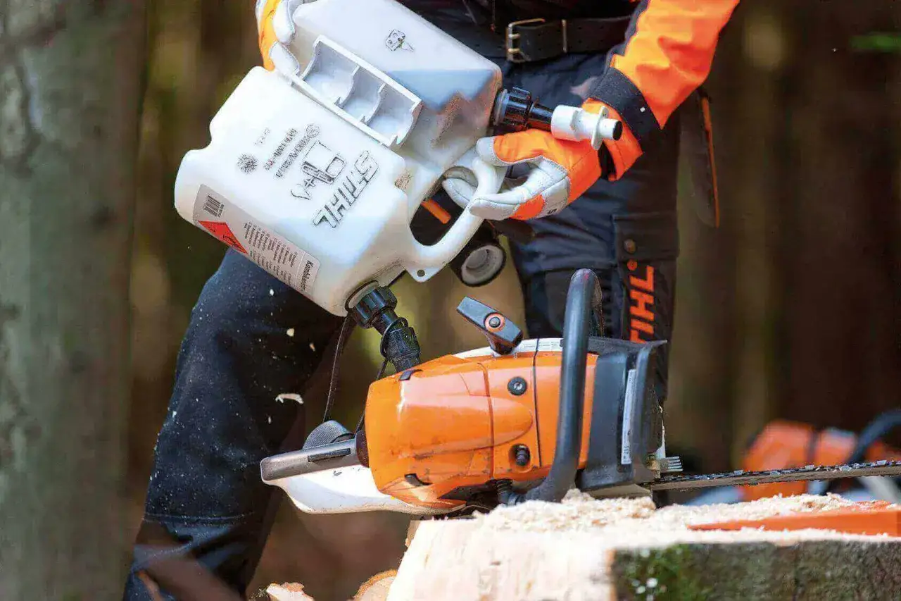 chainsaw user mixing fuel