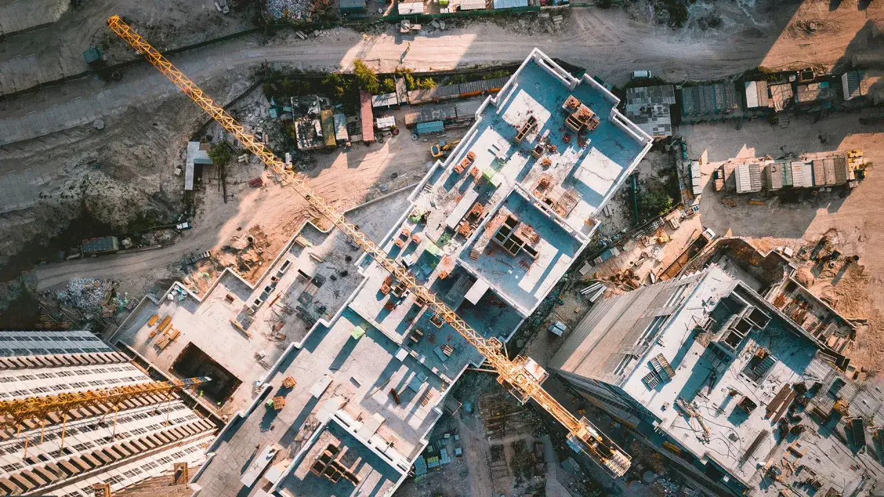Aerial view of a construction site, showcasing the use of drones in construction for surveying and progress monitoring.