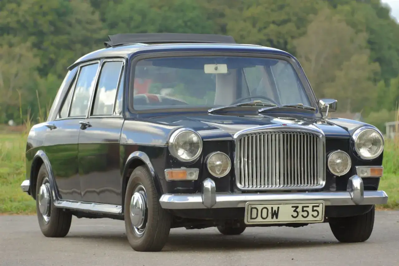 En mörkblå BMC 1100 med taklucka står parkerad utomhus.