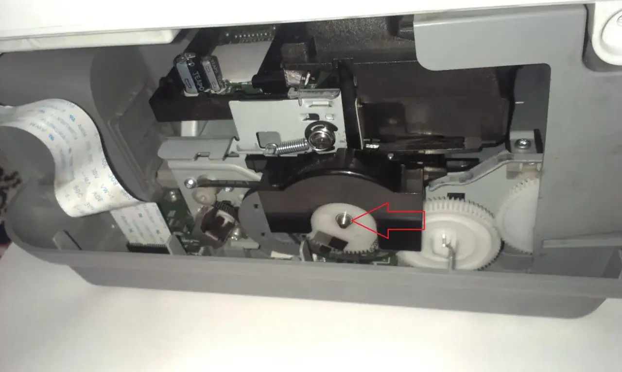 Mechanizm drukarki, gdzie drukarka nie pobiera papieru. Widoczne trybiki i taśma.
