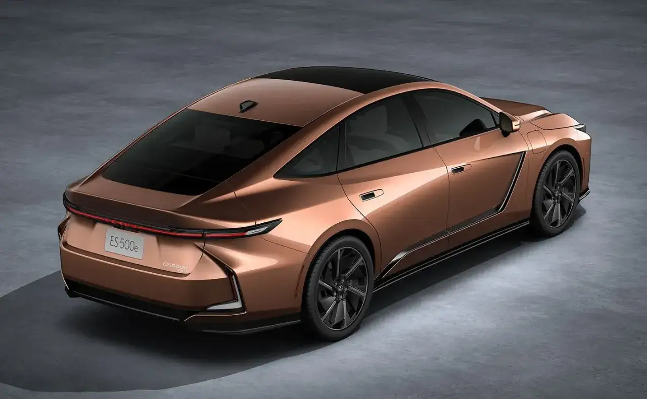 Elegancki, miedziany Lexus ES 500e z 2026 roku, z czarnym dachem i przyciemnianymi szybami, prezentuje futurystyczny design.