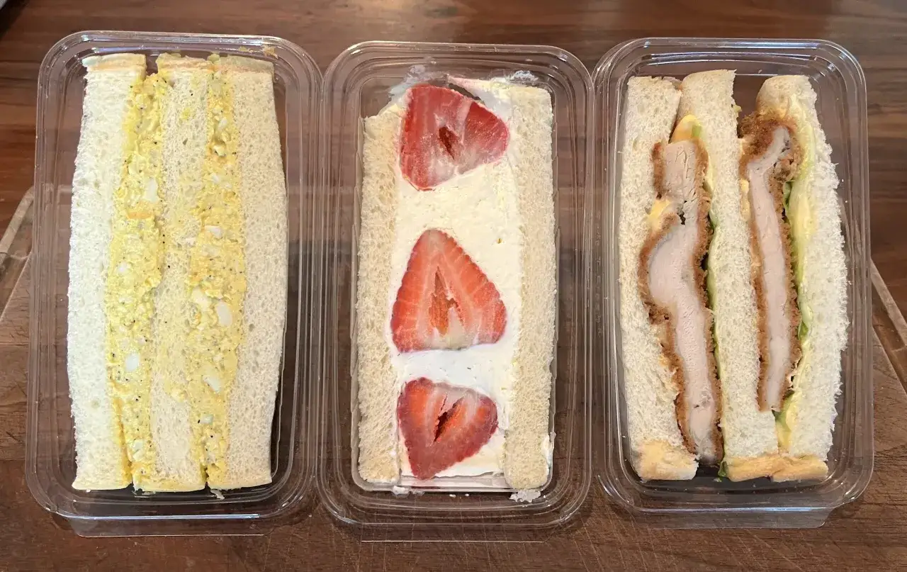 Three sando varieties: egg salad, strawberry cream, and chicken katsu.