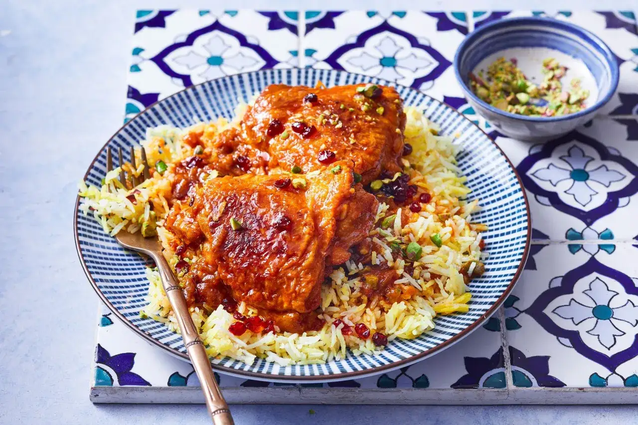En tallrik med zereshk polo, ris med kyckling och berberis. Str&ouml;sslade pistagen&ouml;tter och granat&auml;ppelk&auml;rnor.