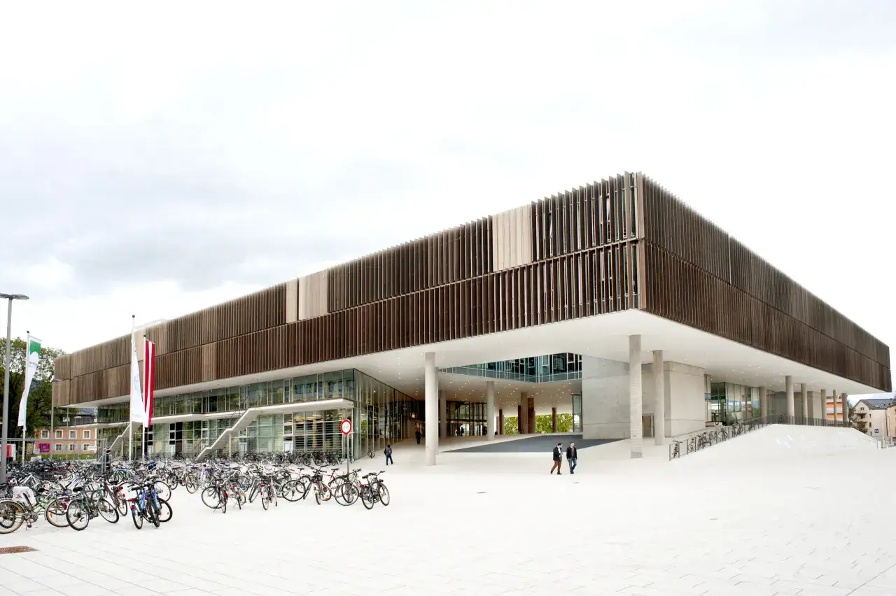 Moderne Architektur des smbs Salzburg mit vielen Fahrr&auml;dern davor.