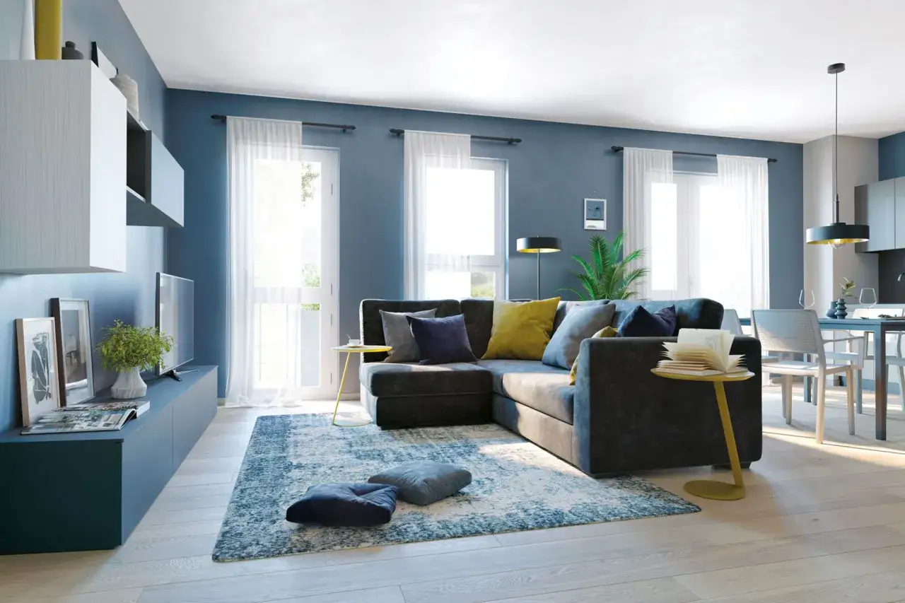 Un soggiorno moderno con pareti blu intenso, un divano grigio scuro e cuscini che creano un contrasto vivace. Blu e grigio stanno bene insieme, creando un'atmosfera accogliente.