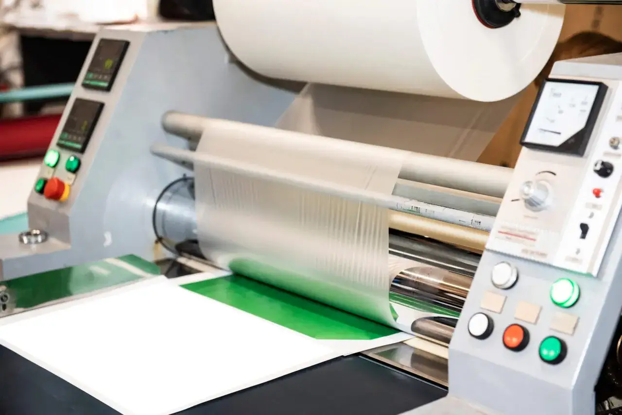 Profesjonalny laminator w akcji, zabezpieczający dokumenty folią. To urządzenie, kt&oacute;re chroni i uszlachetnia wydruki.
