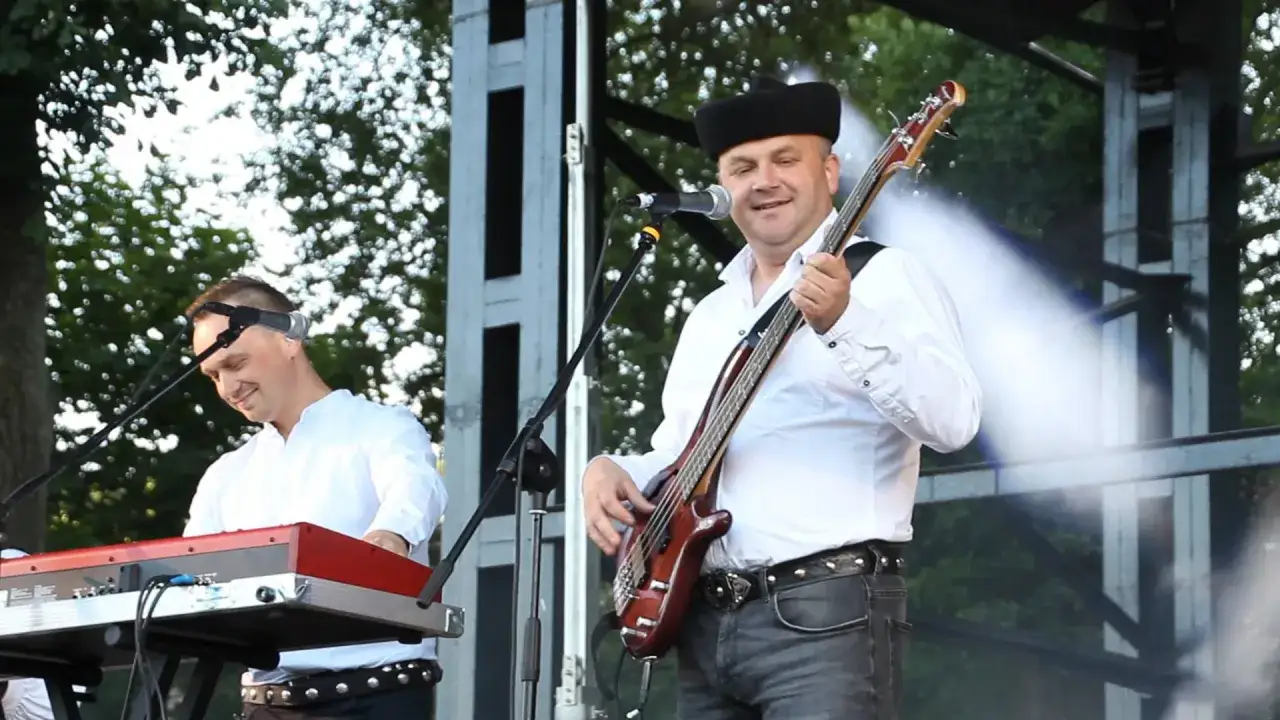 Baciary żyje się raz! Muzyk gra na basie na scenie, obok klawiszowiec.
