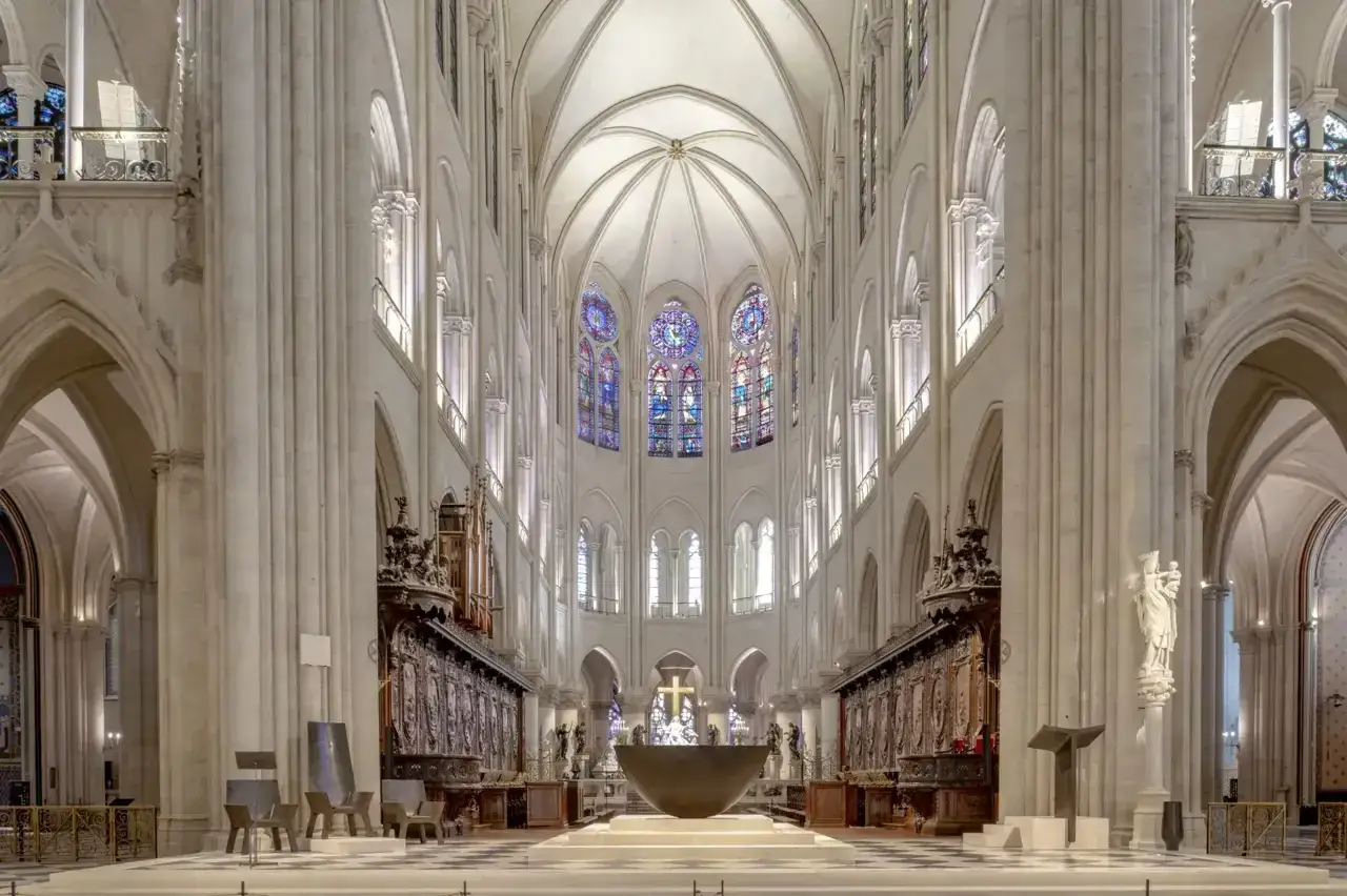 Interior de Notre Dame, con sus arcos g&oacute;ticos, vitrales coloridos y un altar central. Se puede visitar Notre Dame hoy y admirar su majestuosidad.