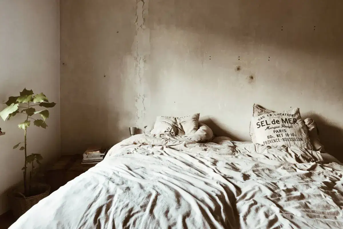 Cama deshecha con un coj&iacute;n de 