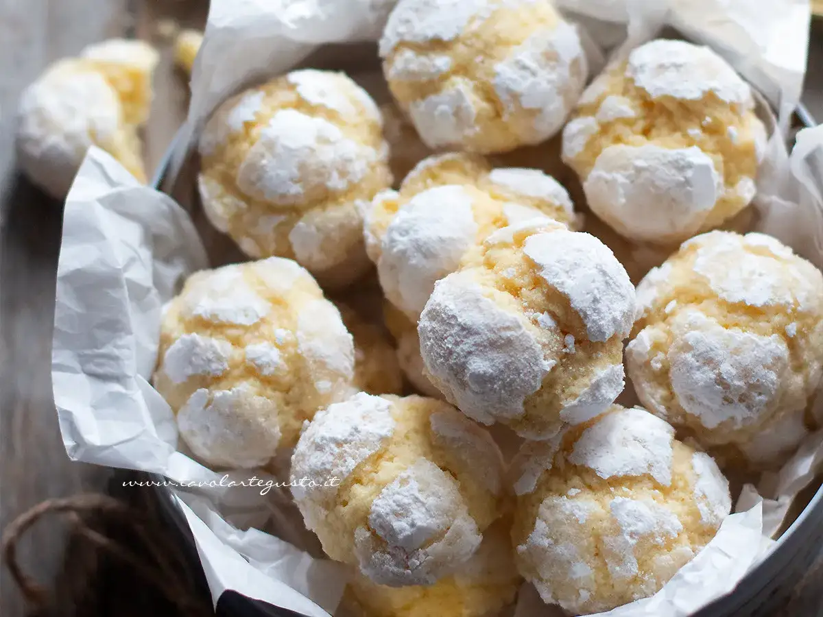 Biscotti con farina di mandorle, dolcemente spolverati di zucchero a velo, invitano a un assaggio goloso.