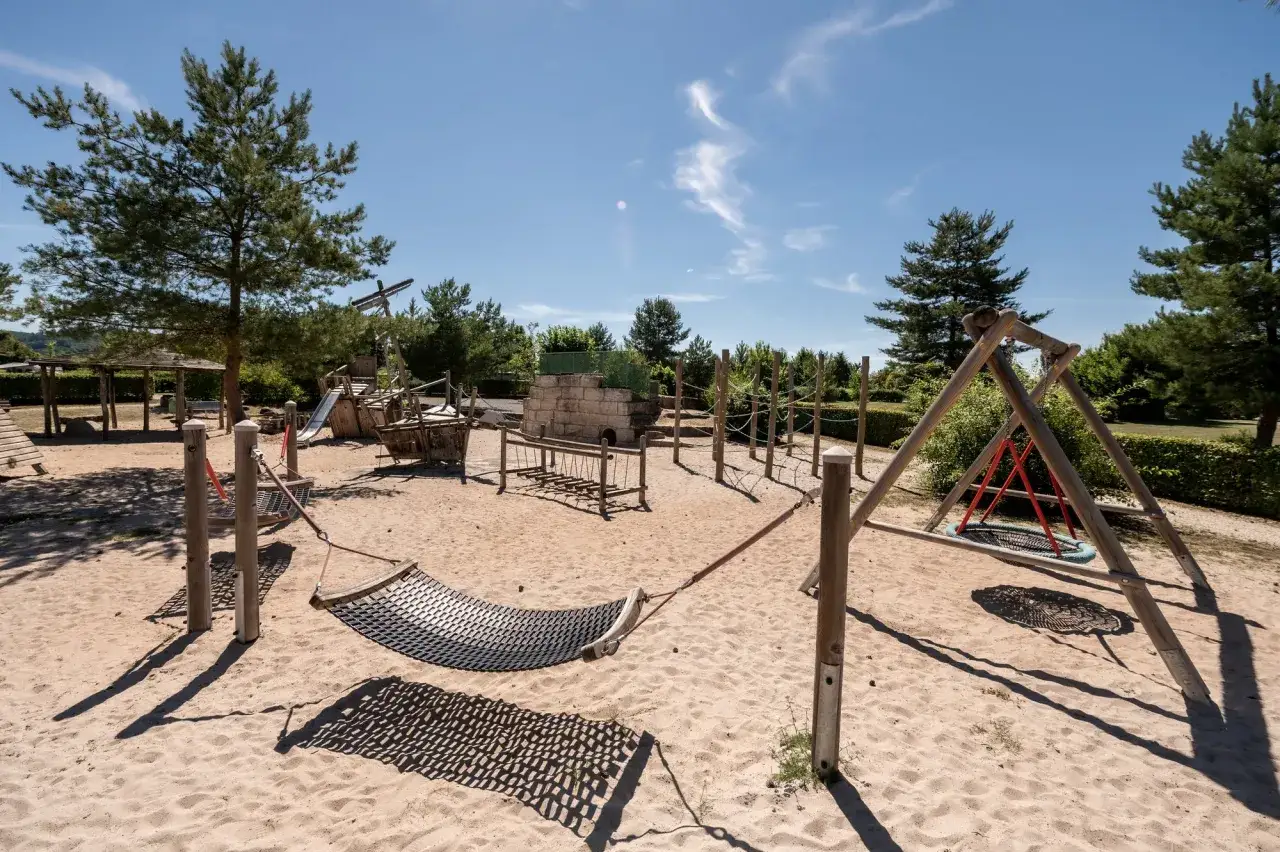 Spielplatz auf einem familien campingplatz mit H&auml;ngematte, Schaukel und Piratenschiff-Kletterger&uuml;st.