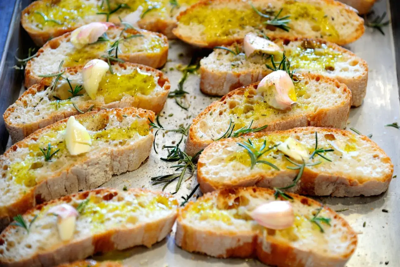 Fettunta cos'è? Bruschette dorate con aglio, rosmarino e olio d'oliva, pronte per essere gustate.
