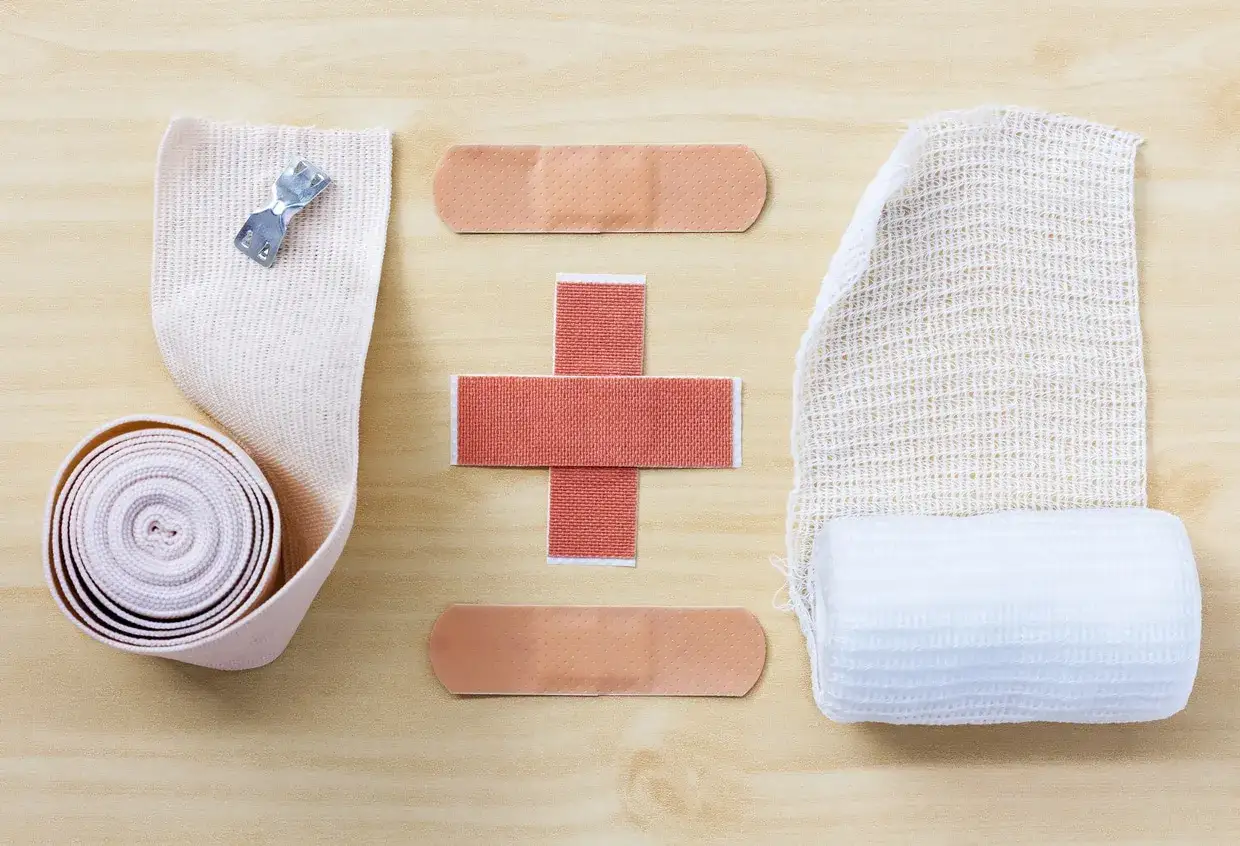 Bandages and gauze are laid out, suggesting that compression therapy works for healing.