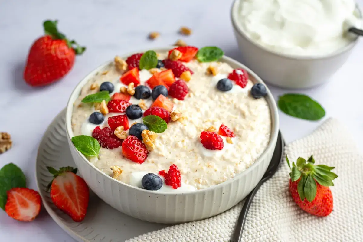 Herzhaftes Porridge mit Beeren und Nüssen. Dieses Gericht zeigt, was ist Haferkleie: eine gesunde Basis für einen guten Start in den Tag.