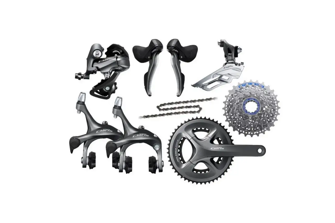 Zestaw komponentów rowerowych Shimano Claris: przerzutka tylna, przednia, manetki, hamulce, korba, kaseta i łańcuch. Idealny do budowy roweru szosowego, uwzględniający ranking przerzutek Shimano.