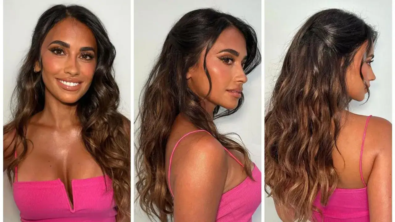 Antonella Roccuzzo, żona Messiego, w różowym topie z wycięciem. Jej długie, falowane włosy i makijaż podkreślają urodę.
