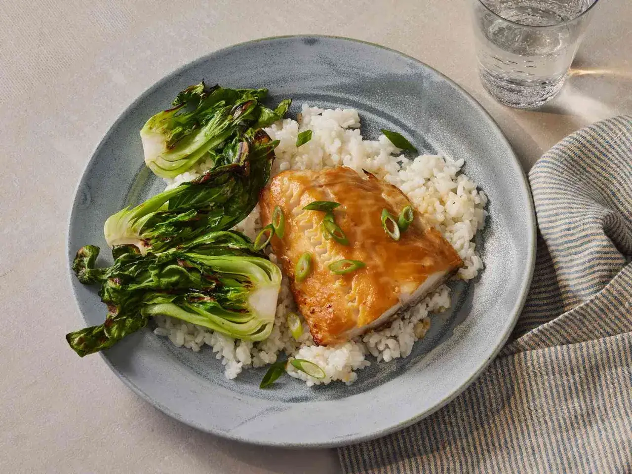 A delicious Nobu miso black cod recipe served with white rice and bok choy.