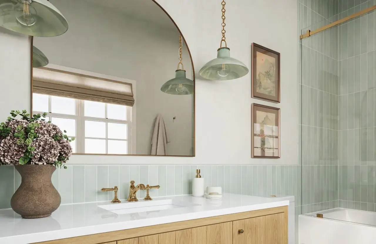 A mint green vertical tile backsplash placement behind a white vanity with gold fixtures.