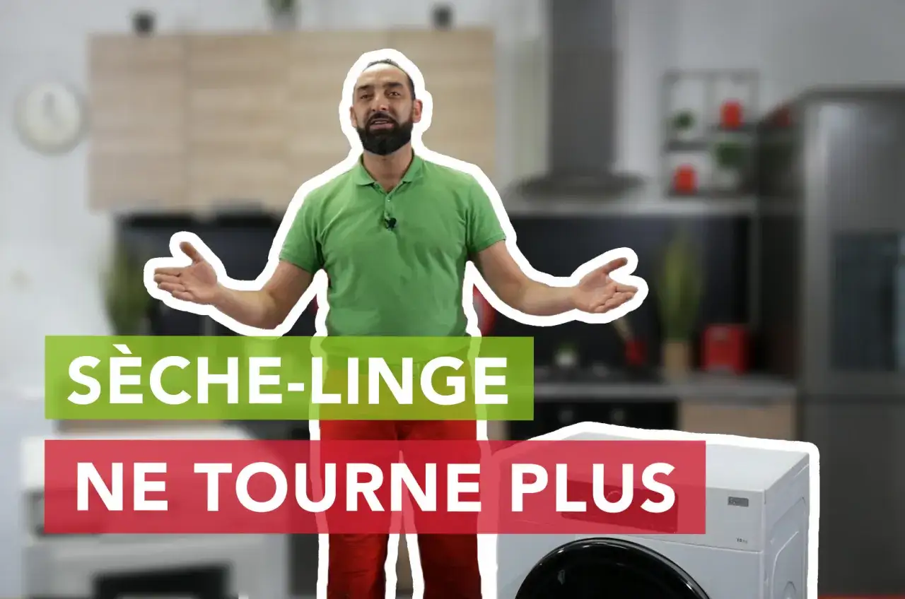 Un homme explique pourquoi son sèche-linge ne tourne plus, devant un appareil et une cuisine floue.