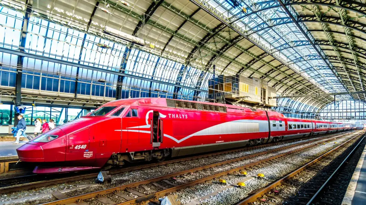 A red Thalys train at a station, ready to take passengers to Paris. The journey from Amsterdam is surprisingly short.