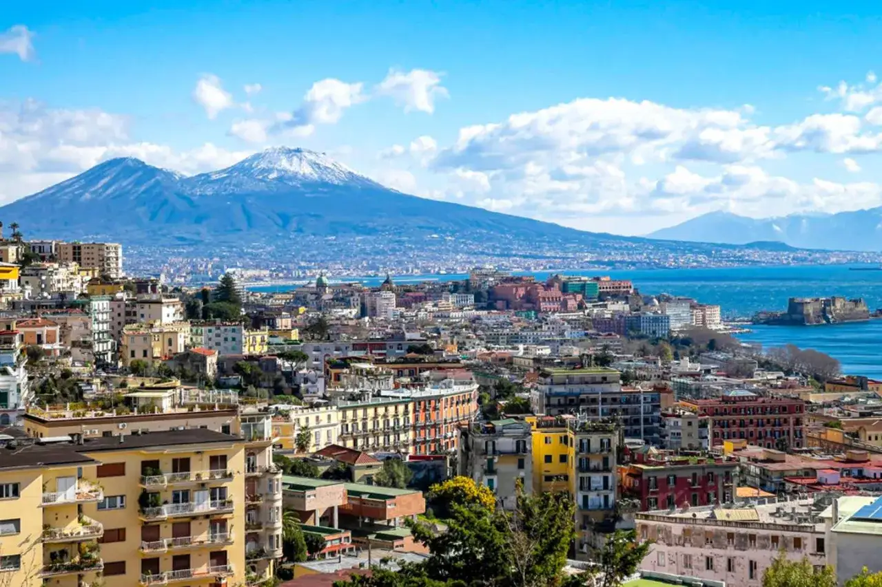 Panoramic view of Naples, Italy, with Mount Vesuvius in the background. Perfect for a Naples Italy itinerary.