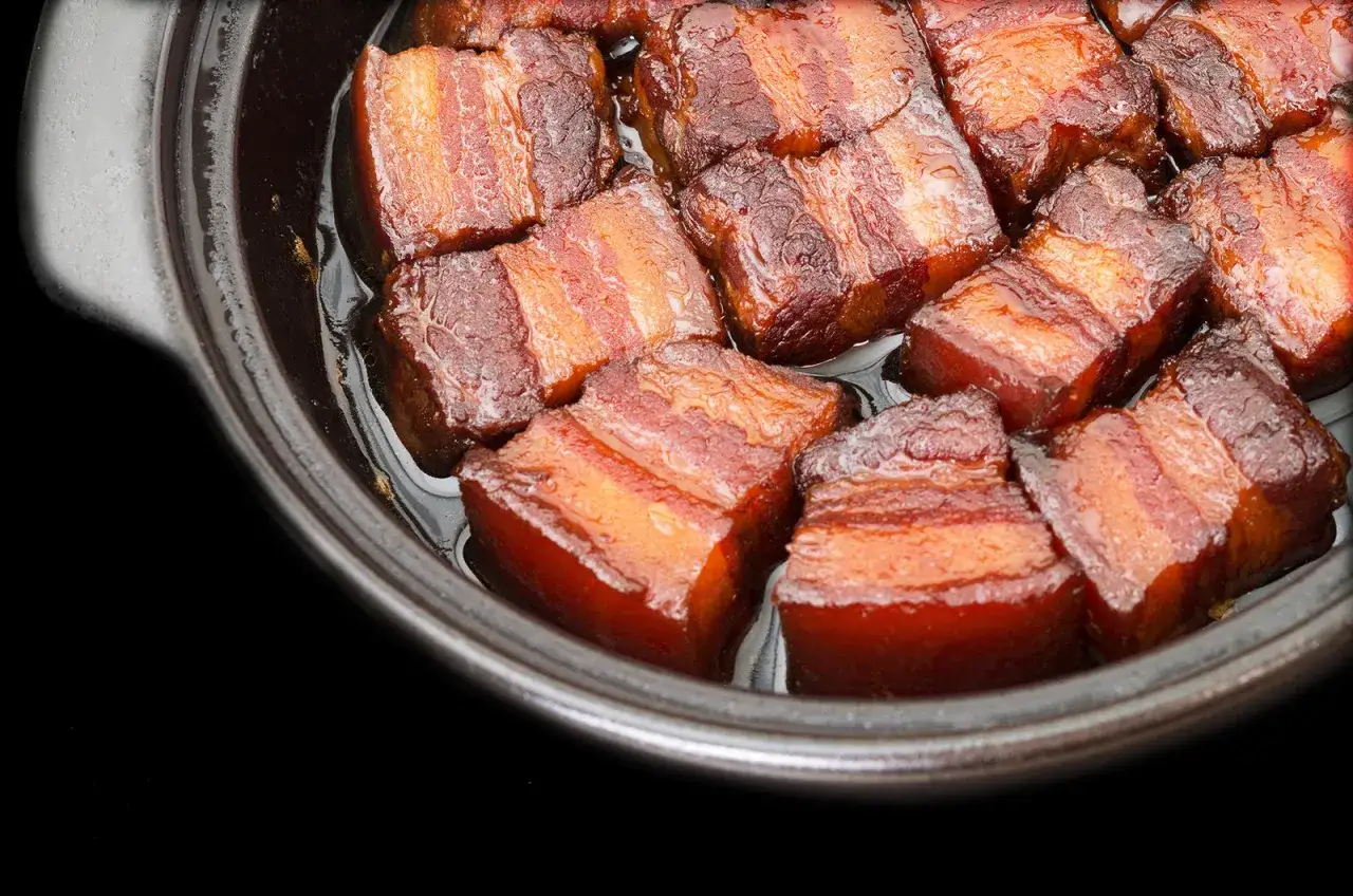 Close-up of succulent pork belly cubes, glistening in a rich sauce, ready for a delicious miso pork belly recipe.