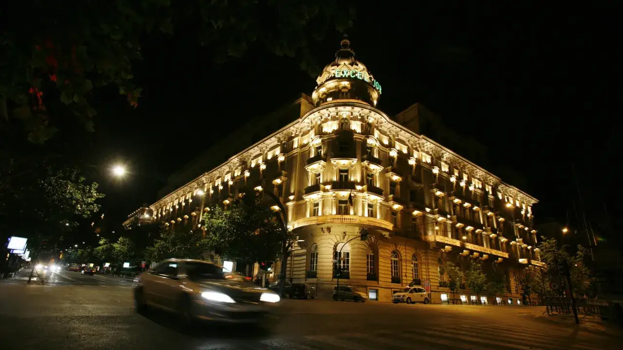 Edificio storico illuminato di notte, un'immagine che evoca la grande bellezza, recensioni positive per questo luogo incantevole.