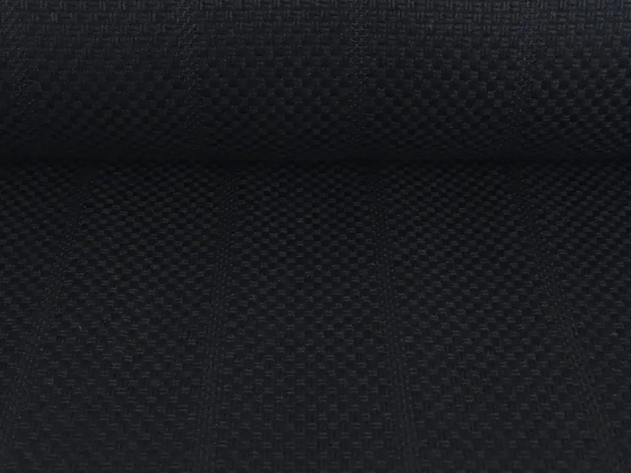 Ciemny, tkany materiał z wyraźnym splotem, przypominający wytrzymały nylon.