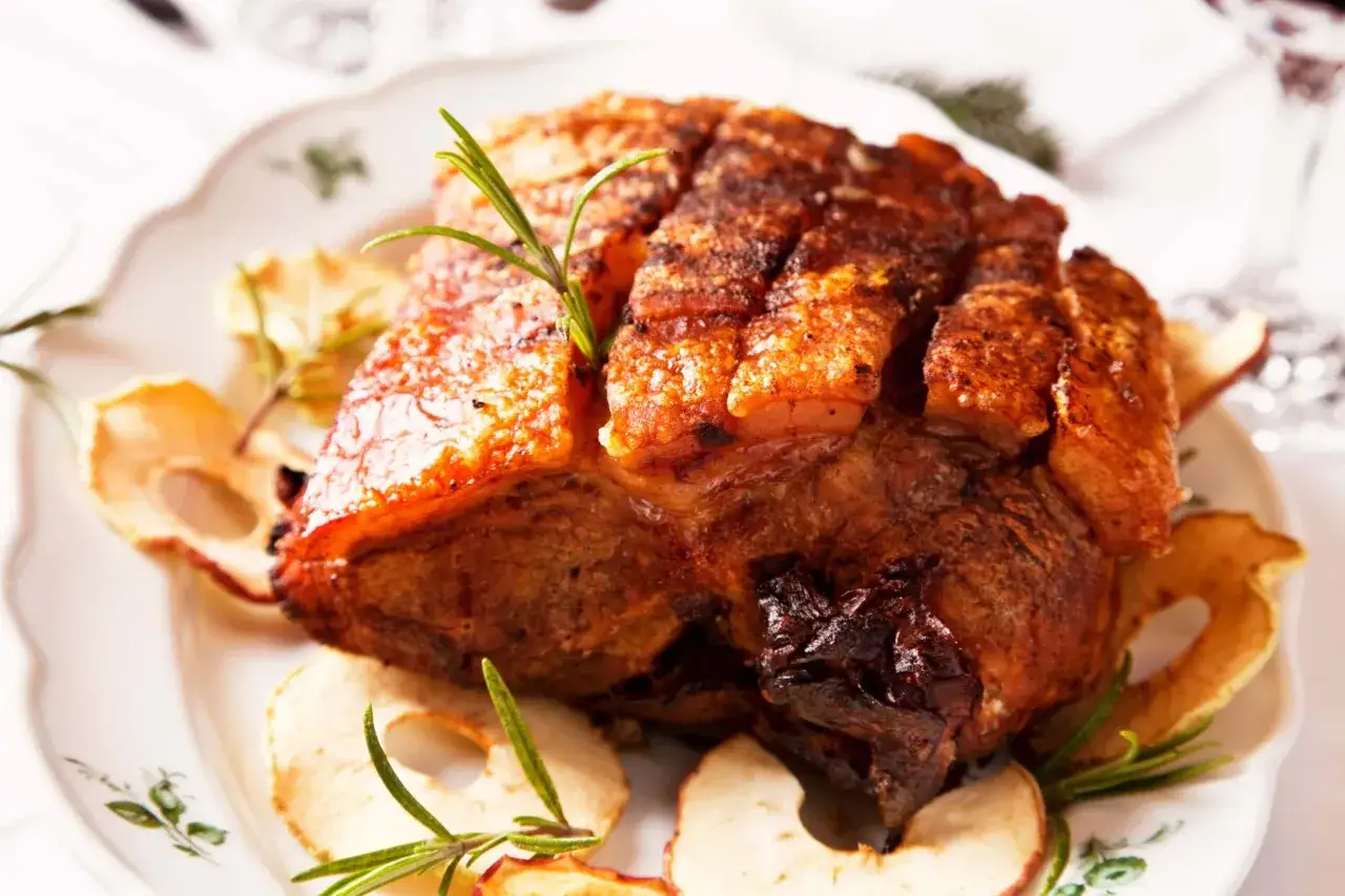 Knuspriger Braten mit Rosmarin und Apfelscheiben. Ein Festmahl, das den wahren **sattelschwein geschmack** verspricht.