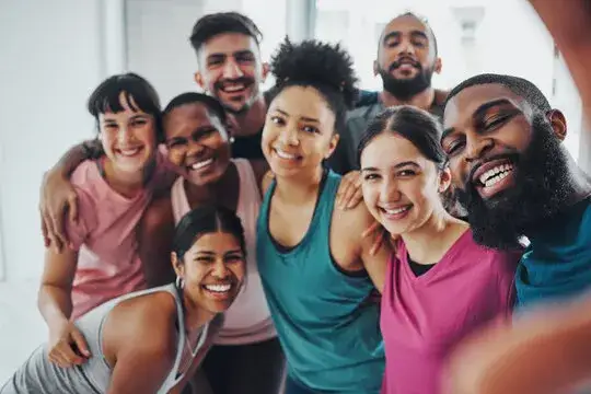 diverse group of people doing crossfit smiling