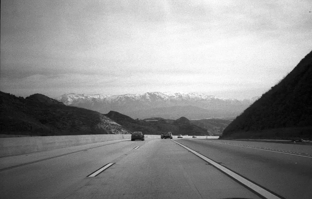 Driving on the delta 400 highway towards snow-capped mountains.