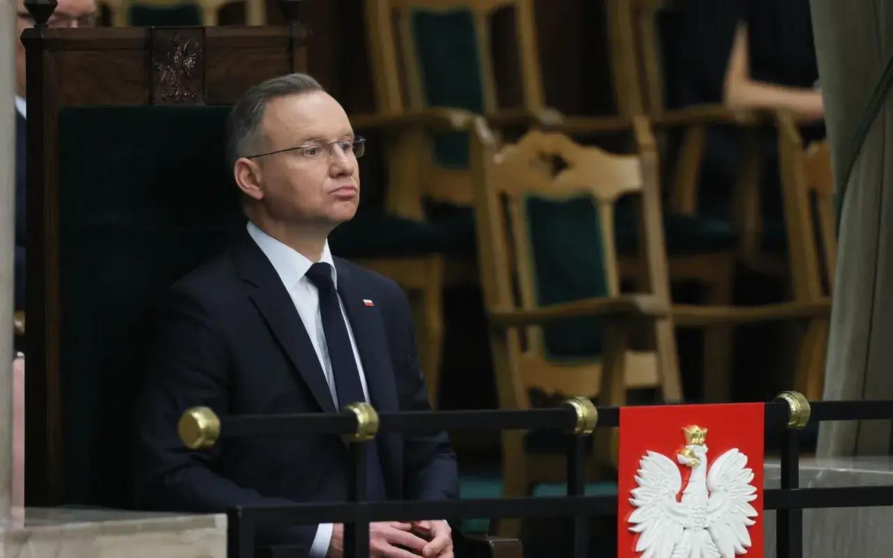 Prezydent w garniturze siedzi w fotelu, zastanawiając się, dlaczego ustawa o mowie nienawiści nie została podpisana przed marcem 2026.