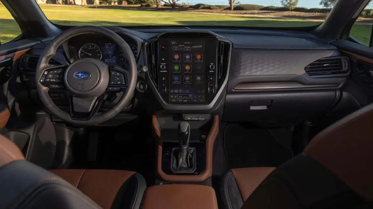 Wnętrze Subaru Ascent z dużym ekranem dotykowym, kierownicą i brązową tapicerką.
