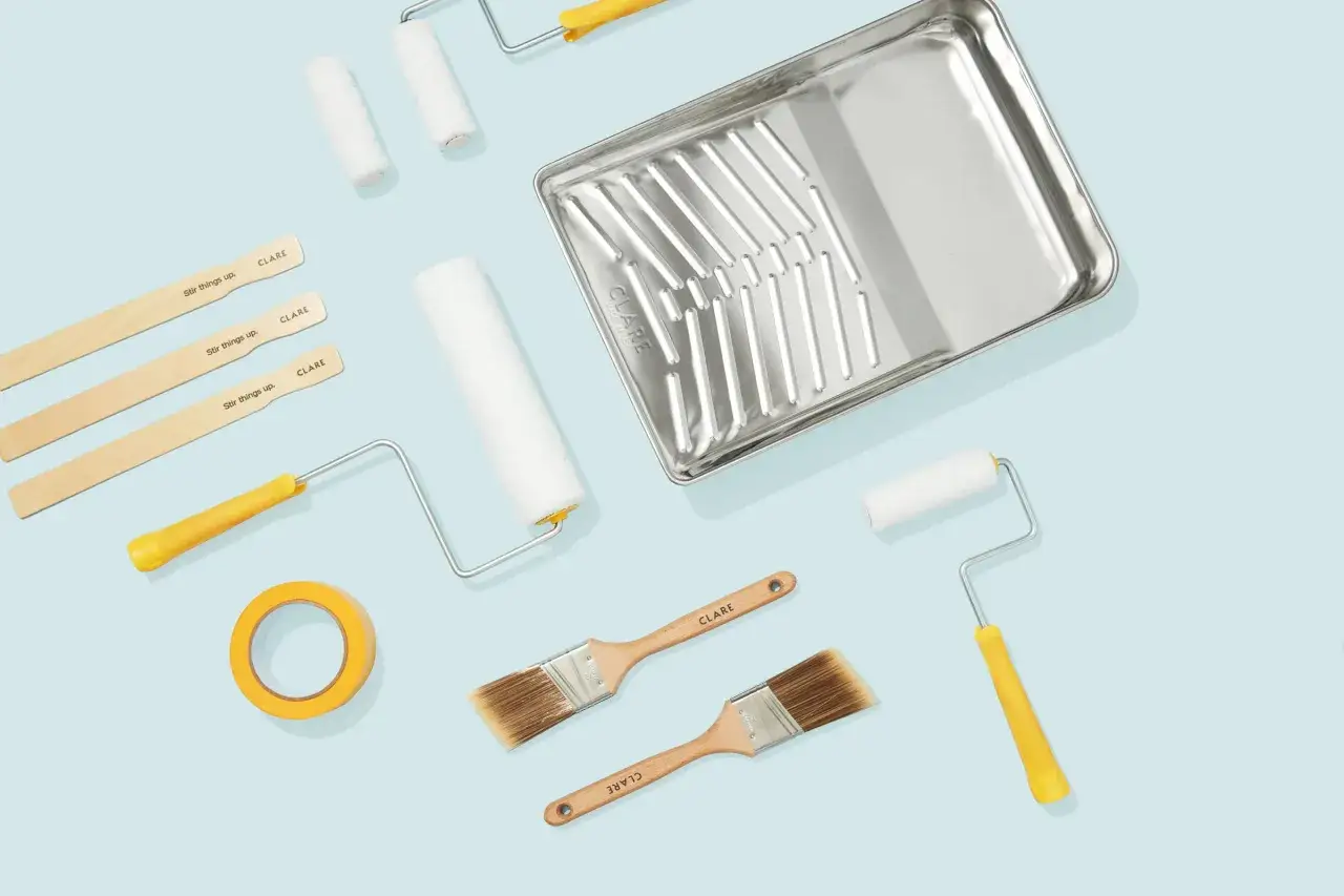 Paint rollers, brushes, a tray, tape, and stir sticks are what you need to paint a room.