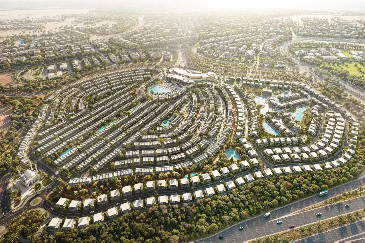 Nowoczesne osiedle z basenami i zielenią, przypominające luksusowe dzielnice w **Abu Zabi czy Dubaju**.