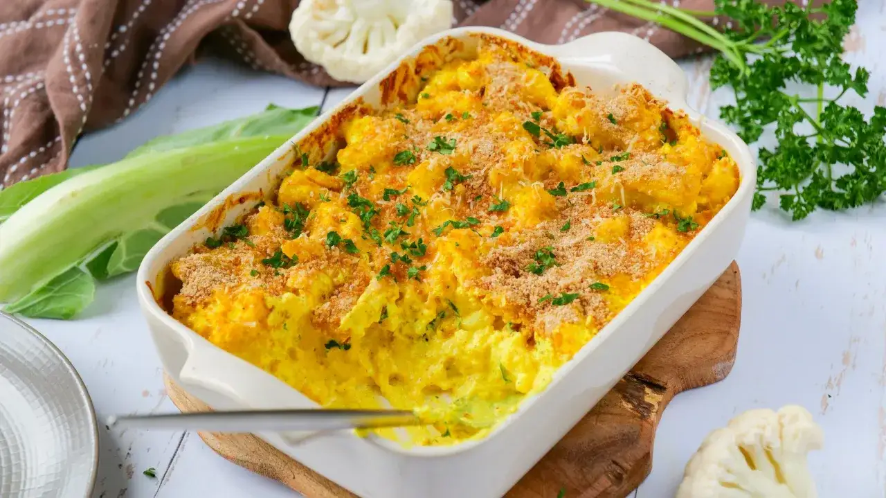 Gratin de chou-fleur crémeux et doré, saupoudré de persil frais et de chapelure croustillante. Un délice réconfortant.