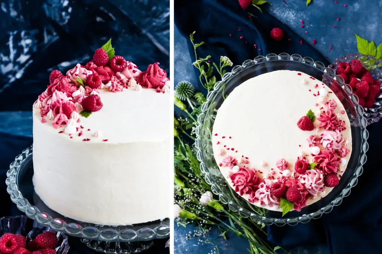 Himbeertorte rezept: Eine weiße Torte mit Himbeer-Buttercreme-Rosen, frischen Himbeeren und kleinen Baiser-Tupfern.