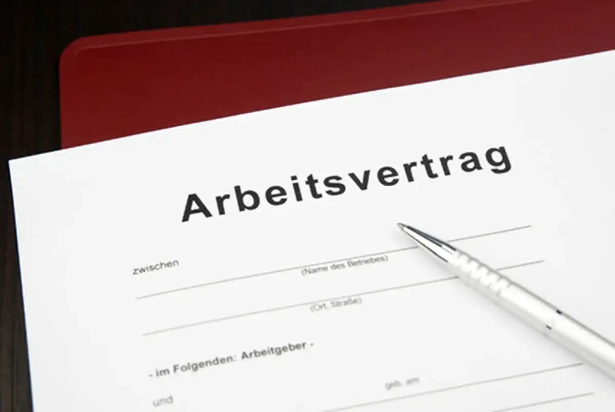 Arbeitsvertrag mit befristung mit sachgrund. Ein Stift liegt bereit, um die Details des Vertrags zu unterzeichnen.