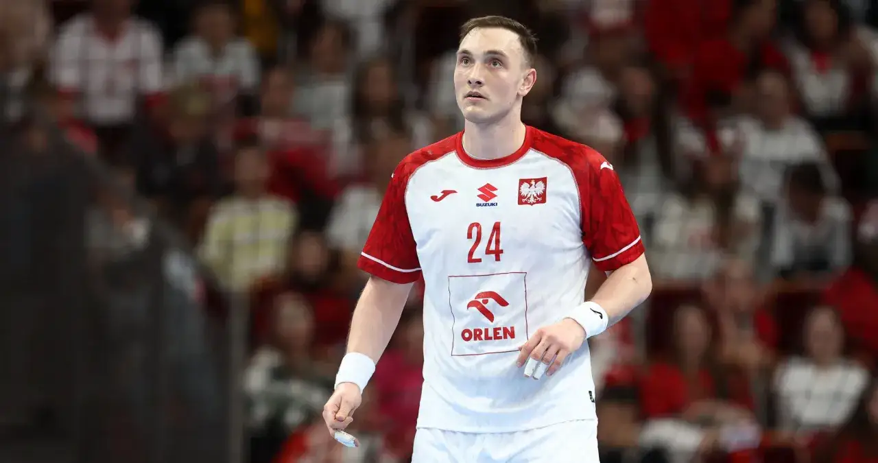 Wiktor Jankowski, numer 24, w białej koszulce z czerwonymi rękawami, z orłem na piersi, gotowy do gry.