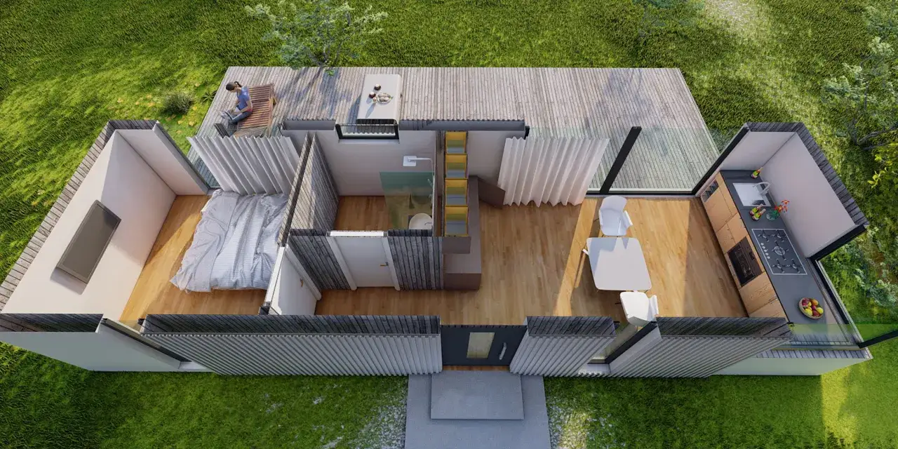 Projekt domu 35m2: sypialnia, łazienka, kuchnia i salon z jadalnią. Na tarasie osoba z laptopem.