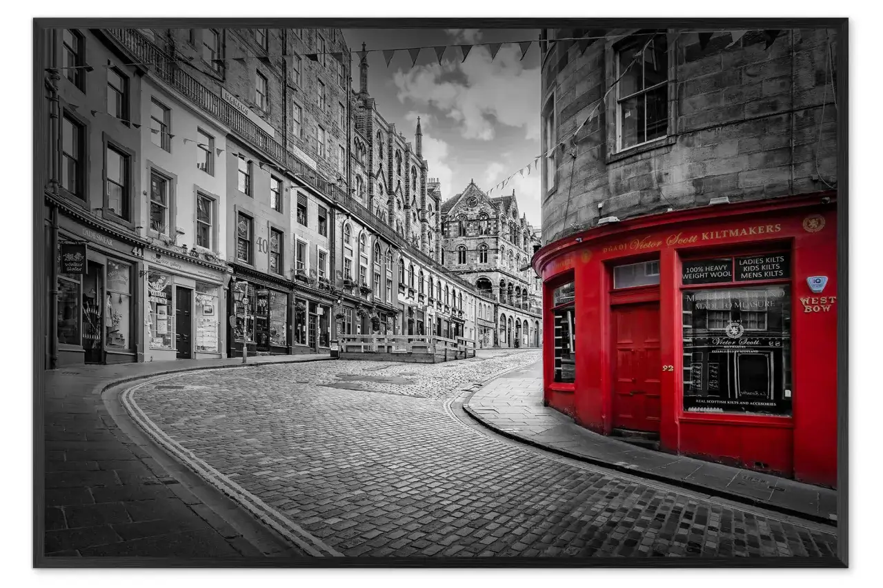 Cobblestone street with a vibrant red kiltmaker shop, evoking a classic London aesthetic.