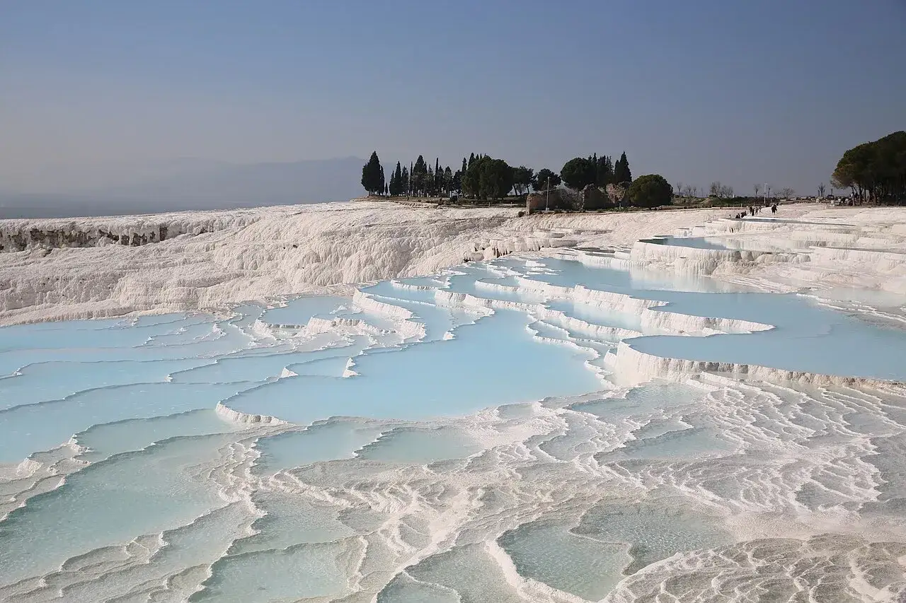 Travertine terraces with turquoise pools in western Turkey, a stunning natural wonder.