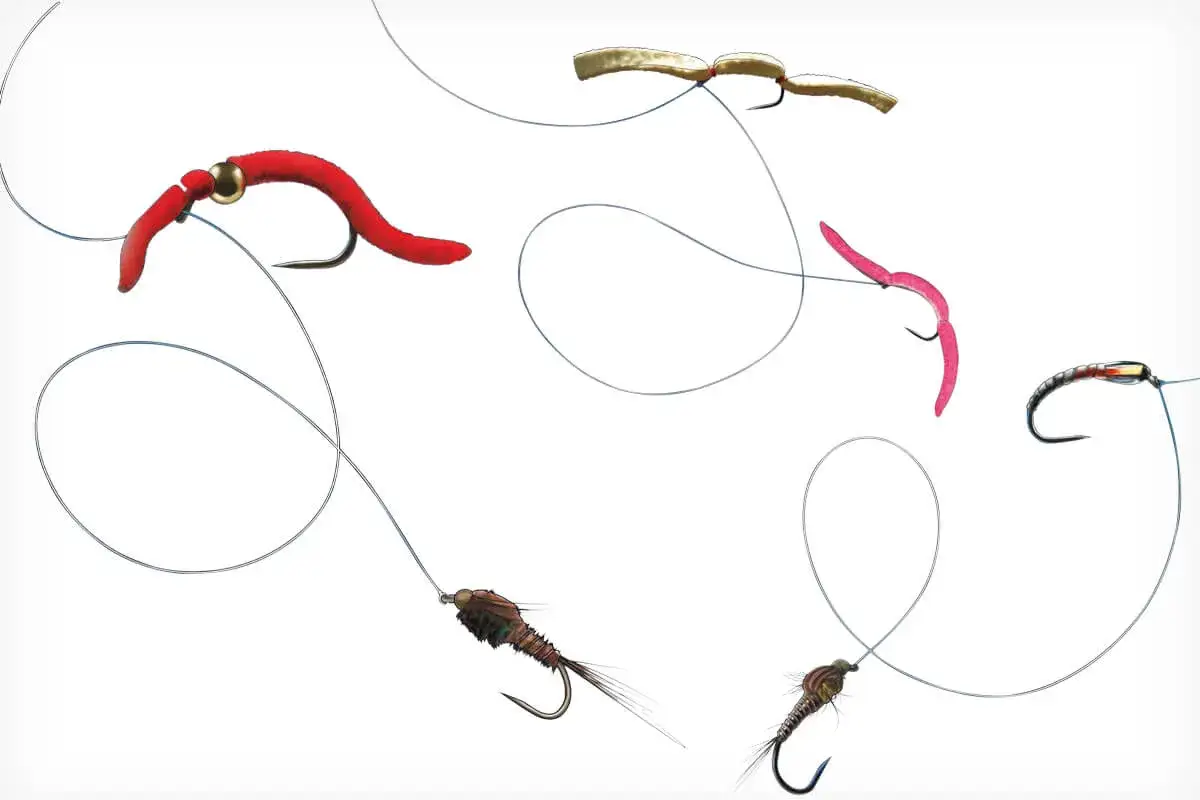 Verschiedene Fliegen f&uuml;r die fliegenfischen montage: rote und pinke Wurm-Imitationen, zwei Nymphen und eine helle Fliege.