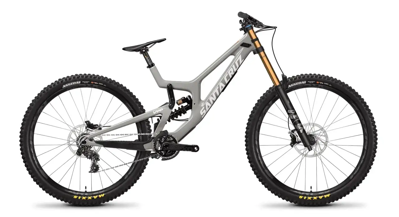 A grey Santa Cruz V10 downhill bike, ready for a review. Features include Fox 40 forks and Maxxis tires.