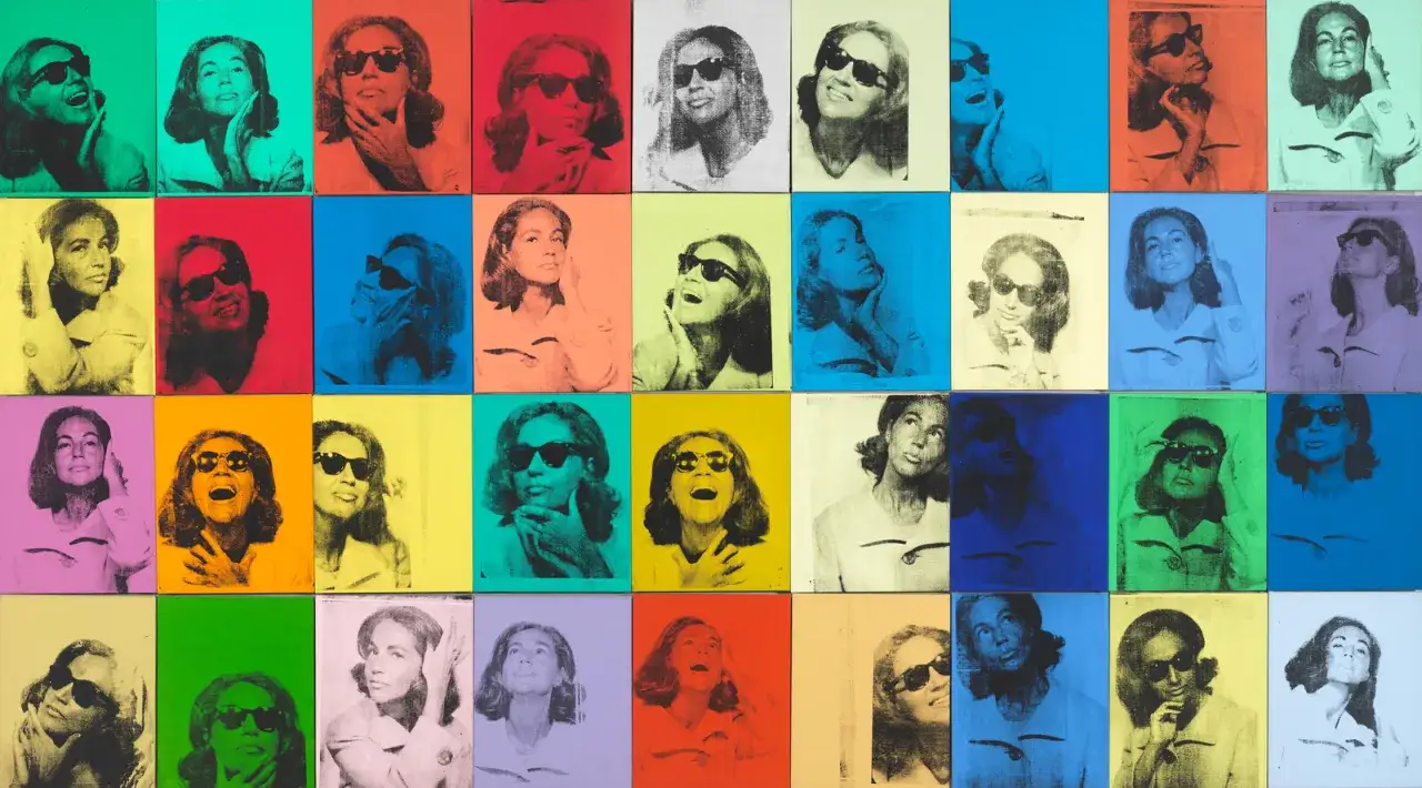 Andy Warhol repetition art showcases a woman in sunglasses across a grid of vibrant, colorful panels, each a slightly different pose.