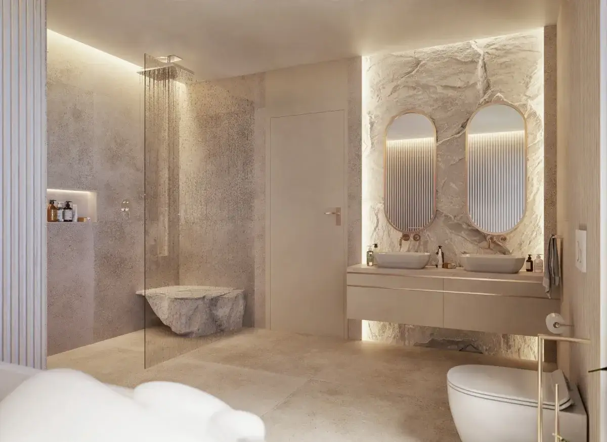 Nowoczesna łazienka bez płytek: kamienne ściany, prysznic z kamienną ławą, podwójna umywalka i podświetlane lustra.