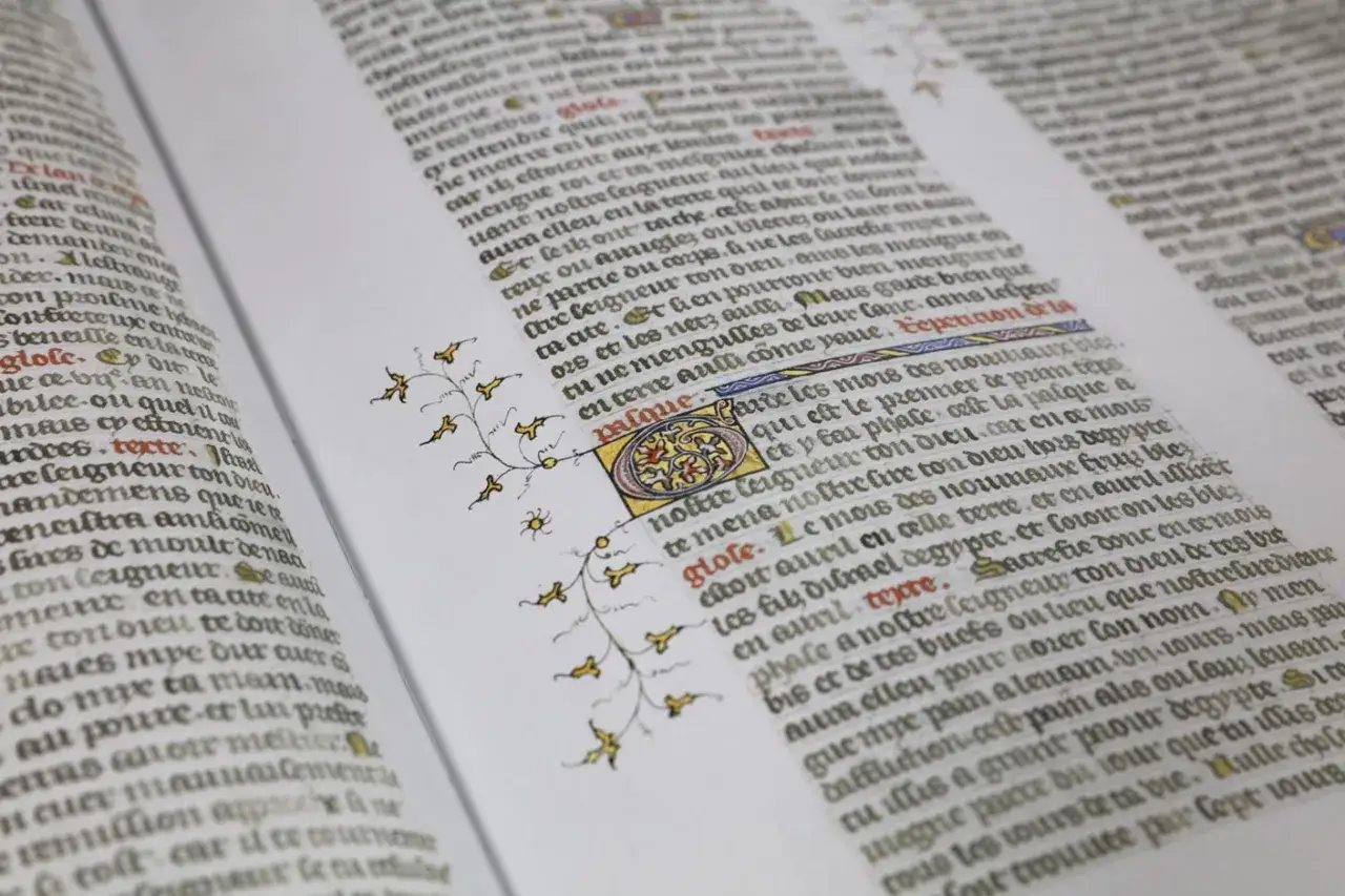 Manuscrit enluminé, texte ancien et nouveau testament. Décoration végétale dorée et lettrine ornée.
